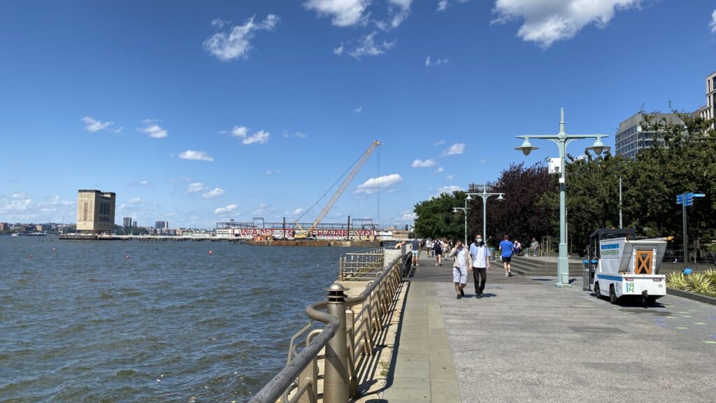 Tree-lined walking path alongside the Hudson River in Riverside Park on Manhattan's Upper West Side.
