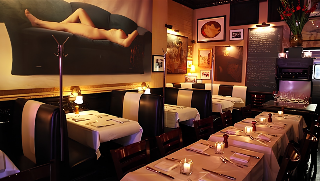 Classic black-and-white leather booths and pink neon light inside Raoul's French bistro in SoHo.