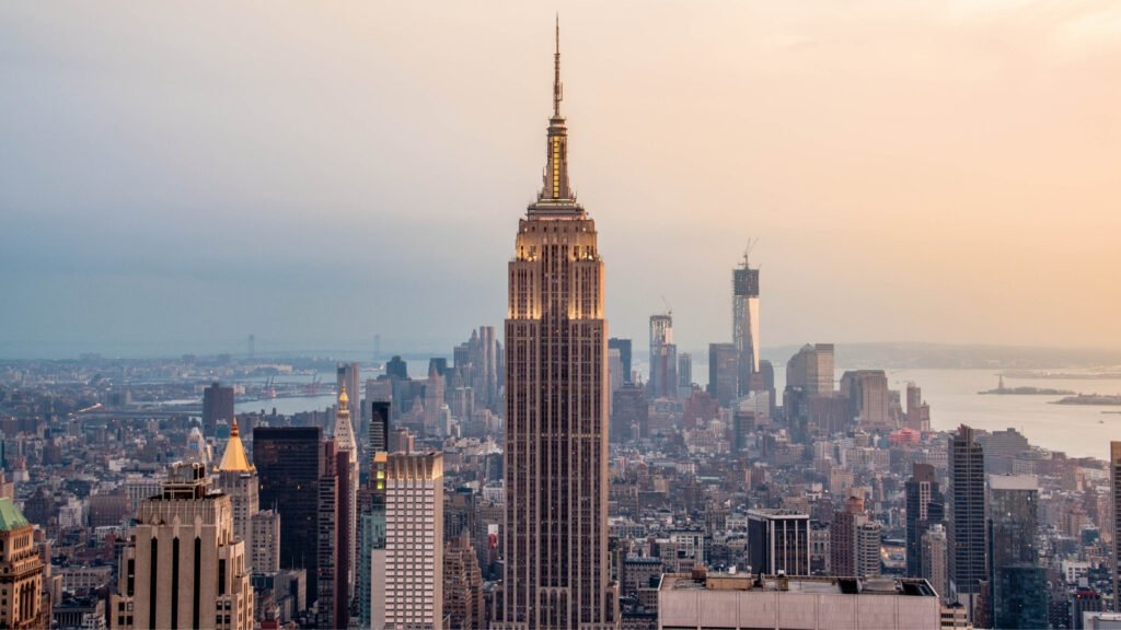 Full view of the Empire State Building towering over Midtown Manhattan skyline.