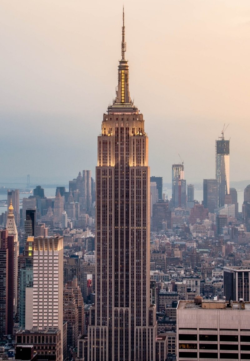 Full view of the Empire State Building towering over the Midtown Manhattan skyline.